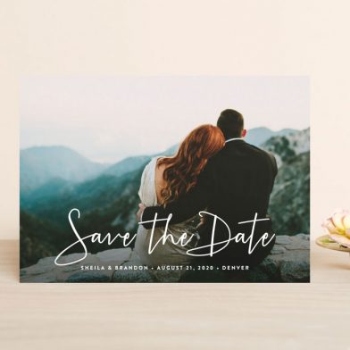 Save the date card with photo of a couple and mountains from Minted.