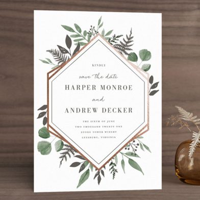 Save the date card with gold foil geometric border and watercolor leaves and foliage from Minted.