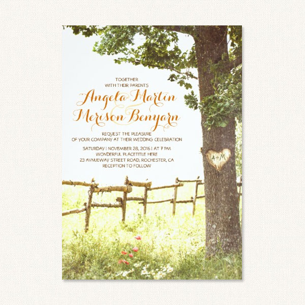 Carved tree wedding invitations with tree, heart carving, meadow, farm fence and flowers.