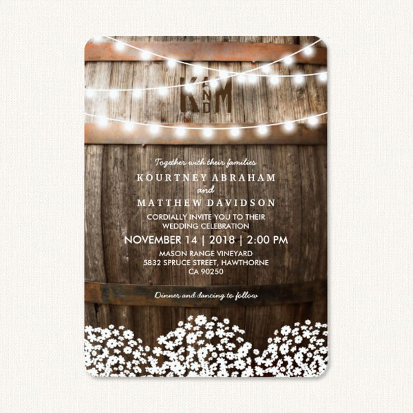 Country style wedding invitations with wood oak barrel, string lights and baby's breath flowers.