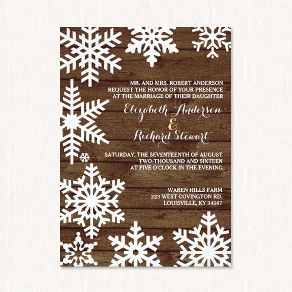 Winter barn wedding invitations with snowflakes and barn wood.