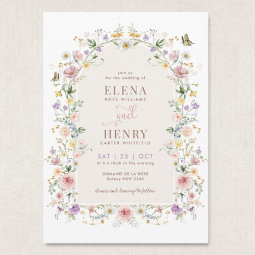 wildflower wedding invitation with pastel meadow flowers forming a floral arch