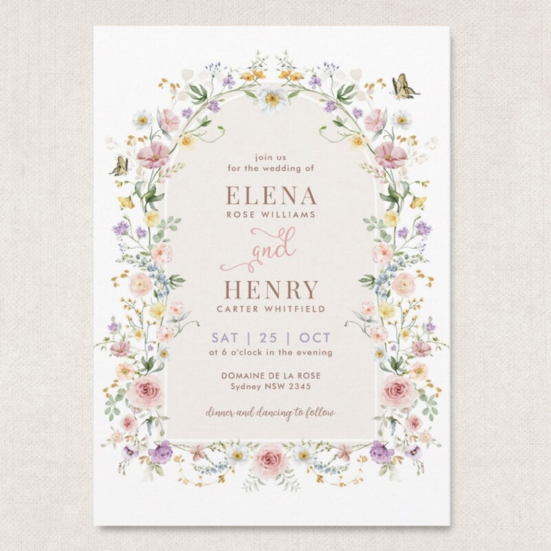 wildflower wedding invitation with pastel meadow flowers forming a floral arch